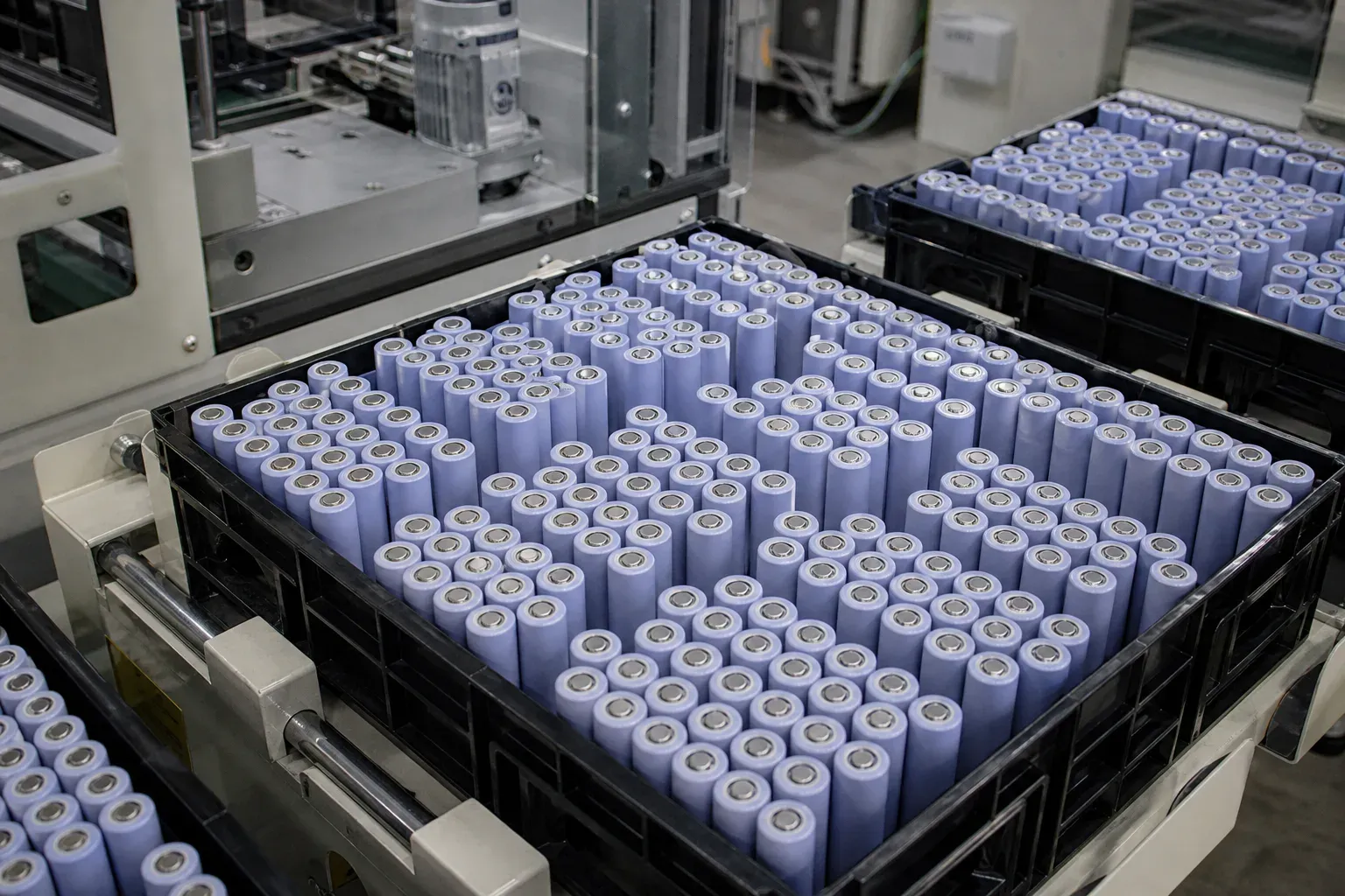 Cylindrical lithium cells packed in trays on a factory line