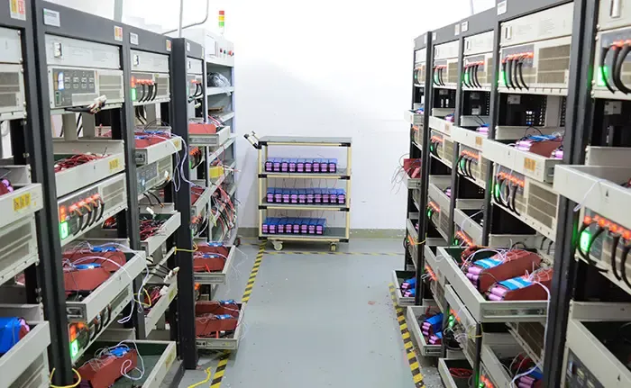 Rows of e-bike battery packs connected on aging test racks